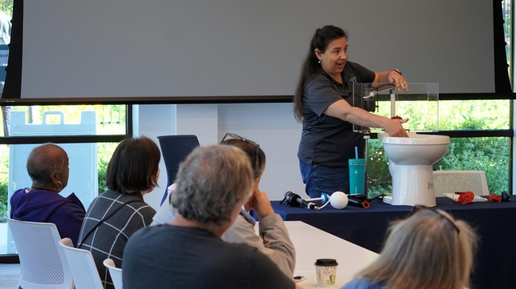 Moulton Niguel staff demonstrate how to repair a toilet leak at Fix-a-Leak workshop.